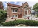 Angle view of the charming brick building with a beautiful stone patio and flower planters at 196 E Madison St, Franklin, IN 46131