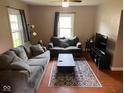 Cozy living room featuring comfortable seating, a patterned rug, and hardwood floors at 209 N Lincoln St, Martinsville, IN 46151