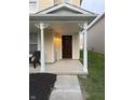 Inviting front porch with decorative columns, mulch landscaping, and a freshly painted front door at 2327 Bristol Dr, Franklin, IN 46131