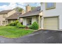 Welcoming exterior with well-kept lawn, and a bench by the front door at 2430 Spring Hill Ct, Indianapolis, IN 46268