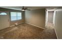 Inviting living room with a ceiling fan, cozy carpet, and a view of the front door at 2453 Larnie Ln, Indianapolis, IN 46219