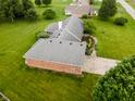 This aerial view showcases the home's roof, brickwork, and surrounding landscape at 2708 N Buck Creek Rd, Greenfield, IN 46140