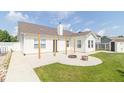 View of the home's backyard with a large patio, lush lawn and storage shed at 2761 Winding Creek Ln, Greenfield, IN 46140
