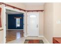 Bright foyer featuring a white front door and view into the living area at 2761 Winding Creek Ln, Greenfield, IN 46140