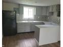 Updated kitchen with gray cabinets, new countertops, and mosaic backsplash at 2855 Walker Ave, Indianapolis, IN 46203