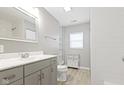 Bright bathroom with a vanity, a large mirror, and a shower with white subway tile at 2940 N Park Ave, Indianapolis, IN 46205