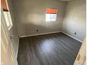 Cozy bedroom with wood-look flooring and ample natural light from a bright window at 3031 E 38Th St, Indianapolis, IN 46218