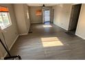 Open concept living room with natural light, neutral walls, and wood-style flooring at 3031 E 38Th St, Indianapolis, IN 46218