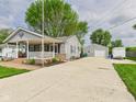 Exterior view showcasing the long driveway leading to the detached garage at 3140 W 18Th St, Anderson, IN 46011