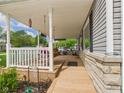 Spacious covered front porch with swing and stone accents at 3140 W 18Th St, Anderson, IN 46011
