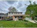 Charming two-story home with a well-maintained lawn, landscaping, and a cozy front porch area at 3232 St Jude Dr, Indianapolis, IN 46227