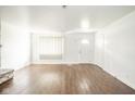 Spacious living room with modern wood floors, white walls, and a large window at 3846 Alsace Pl, Indianapolis, IN 46226