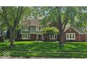 Charming two-story home with a well-manicured lawn and mature trees in a peaceful, established neighborhood at 4619 Allen Dr, Carmel, IN 46033