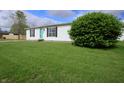 Classic single-story home with a well-manicured lawn and a lovely green shrub in the front yard at 4632 Willowbrook Dr, Columbus, IN 47203