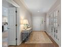 Bright foyer with hardwood floors, console table, and views into other rooms at 4711 Bentley Dr, Carmel, IN 46033