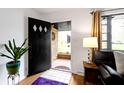 Bright entryway with hardwood floors and view to a charming front porch at 5005 Bonnie Brae St, Indianapolis, IN 46228