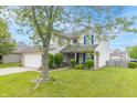 Attractive home with a lush green lawn, a two-car garage, and tasteful landscaping enhancing curb appeal at 5849 Wooden Branch Dr, Indianapolis, IN 46221