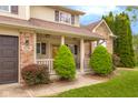 Cozy covered front porch with manicured landscaping and charming 'Welcome' sign at 6096 E Conestoga Trl, Columbus, IN 47203