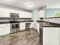 Modern kitchen featuring stainless steel appliances, stylish countertops, and ample cabinet space at 625 Streamside Dr, Greenfield, IN 46140