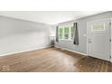 Living room features hardwood floors, lots of light and a front door with glass paneling at 645 W Stop 11 Rd, Indianapolis, IN 46217