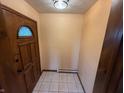Welcoming entryway featuring tile floors, neutral walls, and a front door with decorative glass at 7140 N Michigan Rd, Fairland, IN 46126