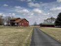 Beautiful home exterior featuring a long driveway and a well-maintained barn on a large property at 7140 N Michigan Rd, Fairland, IN 46126