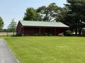 Outbuilding on a lush green lawn; perfect for storage or a workshop at 7140 N Michigan Rd, Fairland, IN 46126