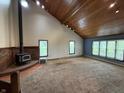Inviting living room with a wood-burning stove, vaulted wood ceilings, and lots of natural light at 7140 N Michigan Rd, Fairland, IN 46126