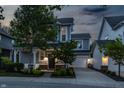 Charming two-story home featuring a covered front porch, attached garage, and well-manicured lawn at 7218 Antiquity Dr, Carmel, IN 46033
