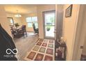 Inviting entryway featuring a colorful rug and convenient console table at 728 Jefferson Park Dr, Pittsboro, IN 46167