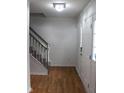 Bright foyer featuring wood floors, a staircase, and a white front door with glass panels at 8551 Walden Trace Dr, Indianapolis, IN 46278