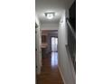 Hallway with wood floors, leading to a kitchen, and view of the backyard through sliding glass doors at 8551 Walden Trace Dr, Indianapolis, IN 46278