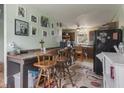 Functional kitchen with dark cabinetry, a breakfast bar, and multiple picture frames on the wall at 907 S Ohio St, Sheridan, IN 46069