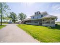 Two-story home with wrap-around porch, spacious lawn, and detached garage at 9579 N Fortville Pike, Fortville, IN 46040