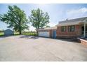 Detached brick garage with a basketball hoop and storage shed at 9579 N Fortville Pike, Fortville, IN 46040