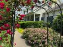 Charming home featuring manicured flower beds, mature landscaping, and a welcoming covered front porch at 9909 E Mcgregor Rd, Indianapolis, IN 46259