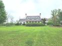 Traditional home with a well-manicured front lawn and mature landscaping in a quiet neighborhood at 9909 E Mcgregor Rd, Indianapolis, IN 46259