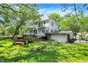 Large backyard with mature trees, a firepit, and a detached garage providing plenty of outdoor space at 1000 E King St, Franklin, IN 46131