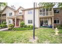 Inviting condo showcases well-maintained lawn, charming balcony, and cozy outdoor seating area at 1046 Timber Creek Dr # 3, Carmel, IN 46032