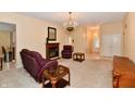 Spacious living room with carpet flooring, a fireplace, chandelier, and recessed lighting at 10713 Stable Dr, Indianapolis, IN 46239