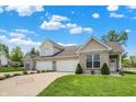 Attractive home featuring a well-maintained lawn, long driveway, and lovely landscaping at 1118 Kristi Ct, Greenwood, IN 46142