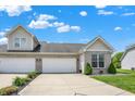 Beautiful home with a spacious driveway leading to a two-car garage and a manicured front lawn at 1118 Kristi Ct, Greenwood, IN 46142