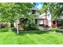 Traditional two-story home showcasing a covered porch, brick accents, and a verdant front yard at 1124 E 35Th St, Indianapolis, IN 46205