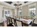 Elegant dining room featuring a coffered ceiling, chandelier, and large windows offering natural light at 11323 Still Creek Dr, Zionsville, IN 46077