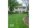 Traditional home featuring a lush front lawn, enhancing the curb appeal and creating an inviting outdoor space at 1138 E 58Th St, Indianapolis, IN 46220