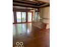 Spacious living room with polished concrete floors, custom cabinets, and large windows offering serene views at 1138 E 58Th St, Indianapolis, IN 46220