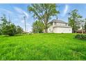 Farmhouse-style house with spacious grassy field, mature trees, and blue skies at 1170 E 400 S, Lebanon, IN 46052