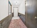 Inviting foyer with paneled walls and neutral-toned carpet at 1209 S Rangeline Rd, Anderson, IN 46012