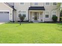 Inviting front entrance with a decorative door, elegant lighting and landscaping at 12115 Flagstone Dr, Fishers, IN 46037
