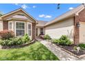 Close up on the charming home's entrance and landscaping at 12256 Sagamore Woods Dr, Fishers, IN 46037